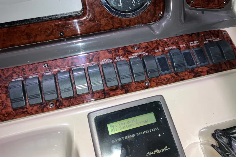 Slide: The Image of Control panel of a 2003 Sea Ray 420 Sundancer boat with switches and systems monitor. - 29