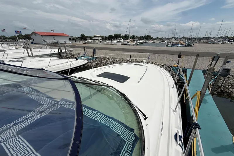 Slide: The Image of 2003 Sea Ray 420 Sundancer docked at a marina with clear skies. - 6