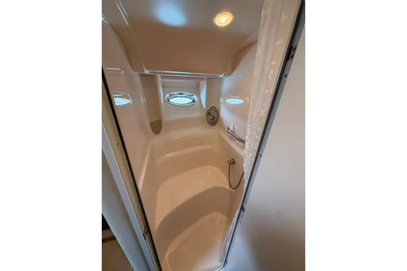 Slide: The Image of Shower area inside 2003 Sea Ray 420 Sundancer yacht, featuring sleek design and porthole window. - 36