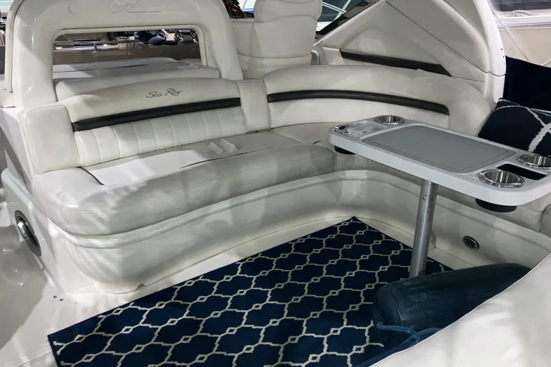 Slide: The Image of Luxurious interior of 2003 Sea Ray 420 Sundancer with white seating and a stylish table. - 21