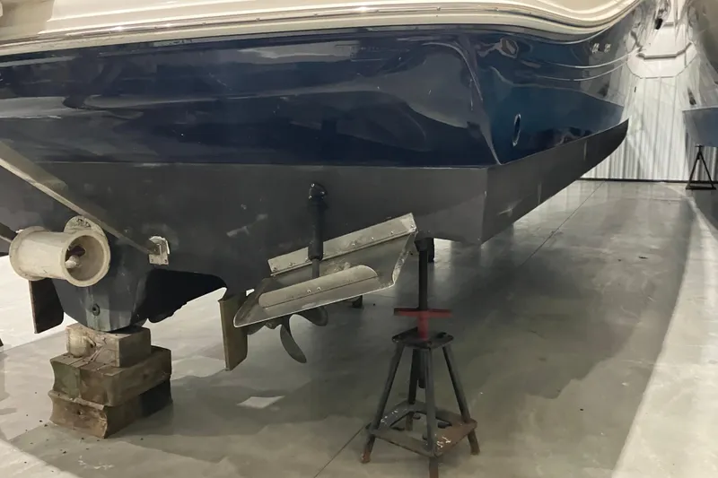 Slide: The Image of 2003 Sea Ray 420 Sundancer boat hull on stands in a storage facility. - 15