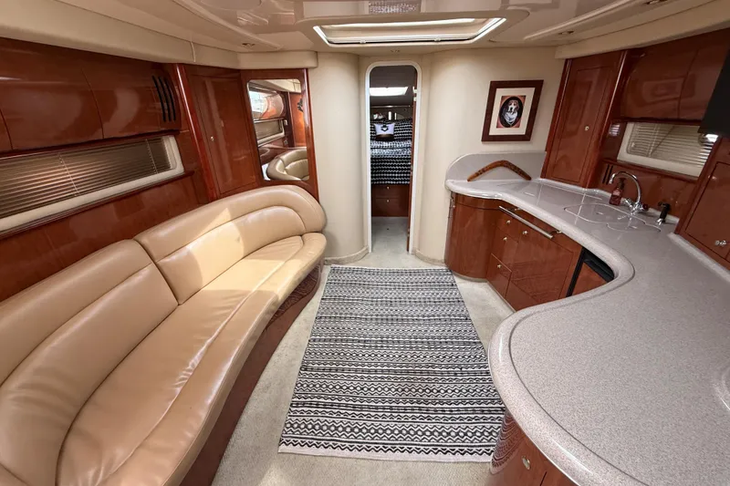 Slide: The Image of Luxurious interior of a 2003 Sea Ray 420 Sundancer yacht with elegant seating and modern amenities. - 33