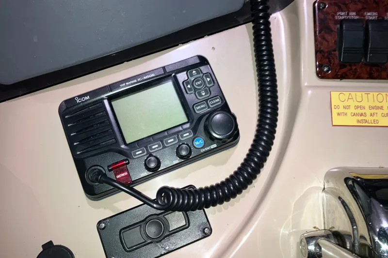 Slide: The Image of VHF marine radio on 2003 Sea Ray 420 Sundancer dashboard with caution label. - 28