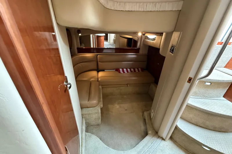 Slide: The Image of Interior of 2003 Sea Ray 420 Sundancer yacht with beige seating and carpeted stairs. - 40