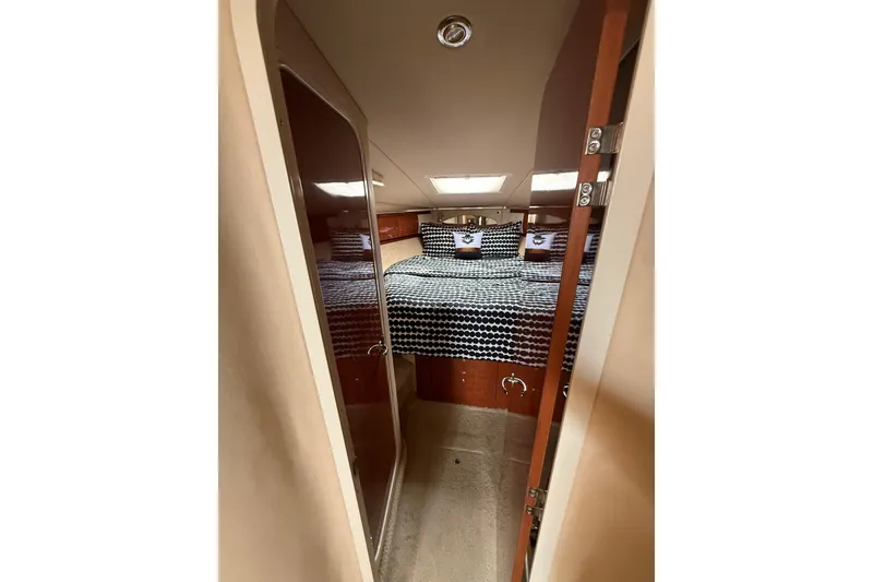 Slide: The Image of Interior cabin of 2003 Sea Ray 420 Sundancer yacht with patterned bedding. - 34