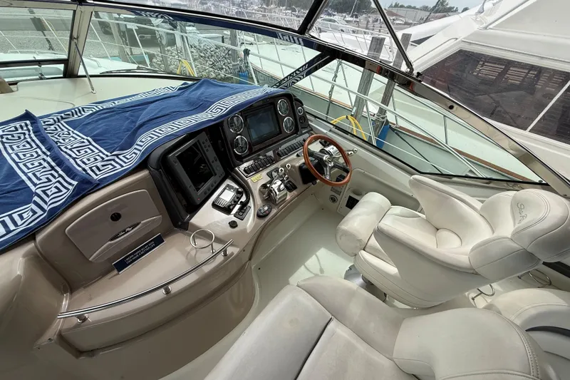 Slide: The Image of Cockpit of 2003 Sea Ray 420 Sundancer with helm, controls, and plush seating. - 25
