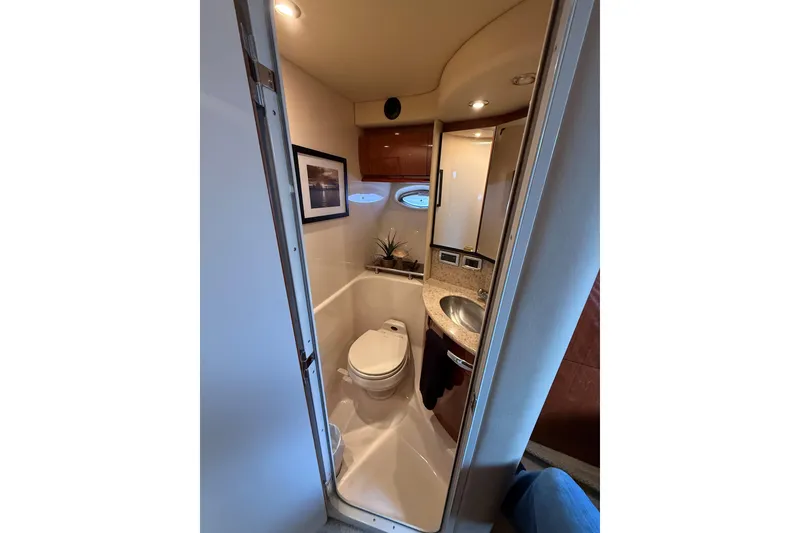 Slide: The Image of Bathroom interior of 2003 Sea Ray 420 Sundancer yacht, featuring toilet and sink. - 35