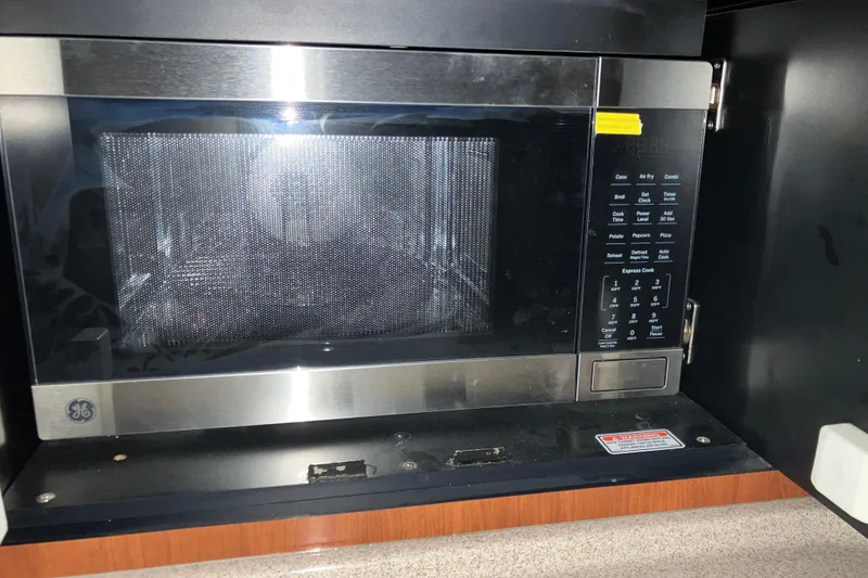 Slide: The Image of GE microwave installed in a 2003 Sea Ray 420 Sundancer yacht kitchen. - 42