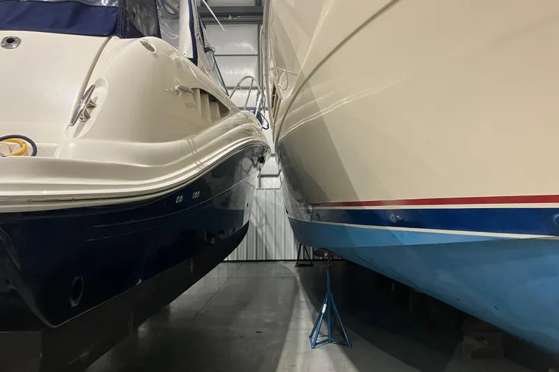 Slide: The Image of Two boats in storage, including a 2003 Sea Ray 420 Sundancer, side by side. - 16