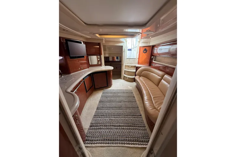 Slide: The Image of Luxurious interior of 2003 Sea Ray 420 Sundancer yacht with leather seating and modern amenities. - 38