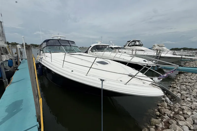 Slide: The Image of 2003 Sea Ray 420 Sundancer yacht docked at marina, showcasing sleek design and luxury features. - 4