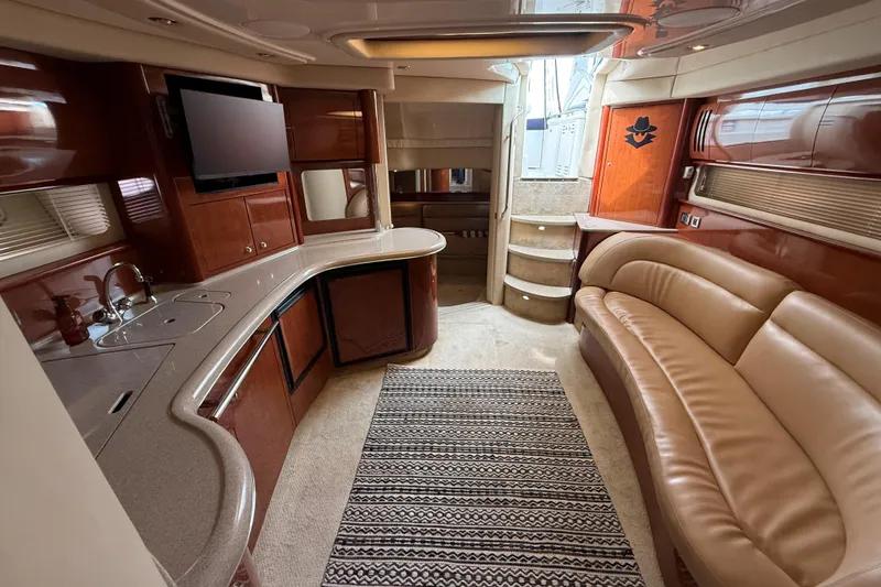 Slide: The Image of Luxurious interior of a 2003 Sea Ray 420 Sundancer yacht with elegant seating and modern amenities. - 39