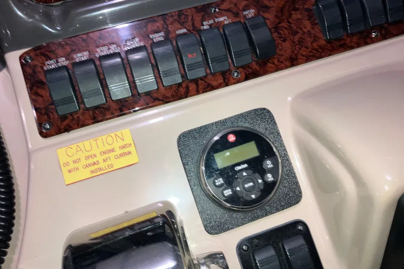 Slide: The Image of Control panel of a 2003 Sea Ray 420 Sundancer with caution label and switches. - 30