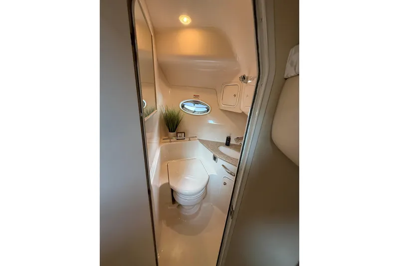 Slide: The Image of 2003 Sea Ray 420 Sundancer bathroom interior with porthole, toilet, and countertop. - 41