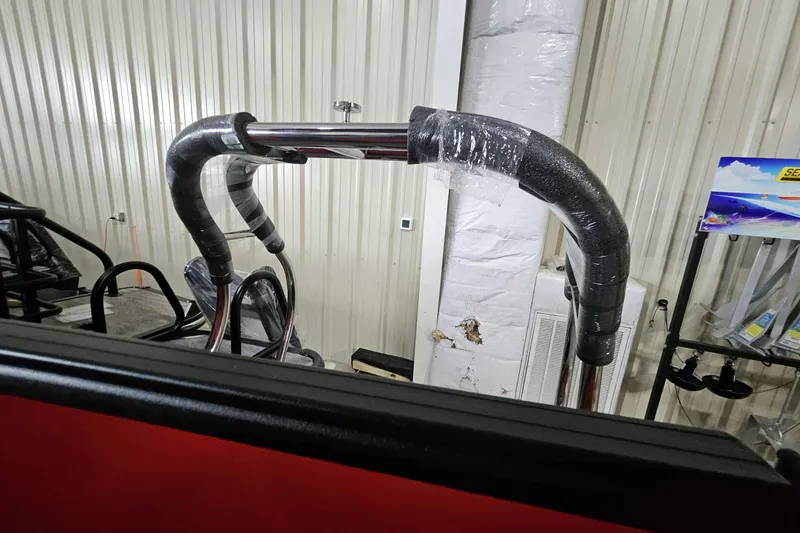 Slide: The Image of 2026 Starcraft EXS 3 boat with protective wrapping in a storage facility. - 12