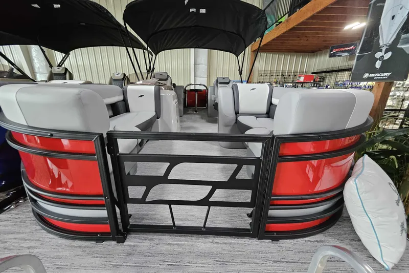 Slide: The Image of 2026 Starcraft EXS 3 pontoon boat with red exterior and spacious seating. - 5