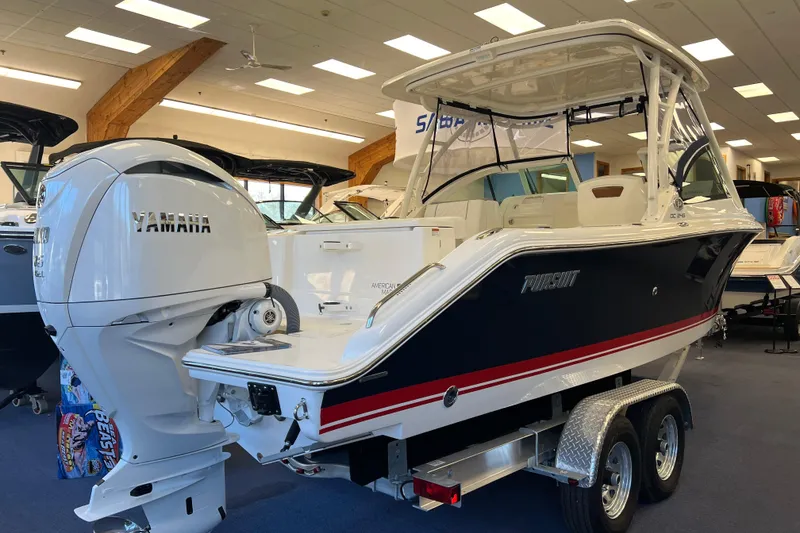 Slide: The Image of 2025 Pursuit DC 246 Dual Console boat with Yamaha engine in showroom. - 1