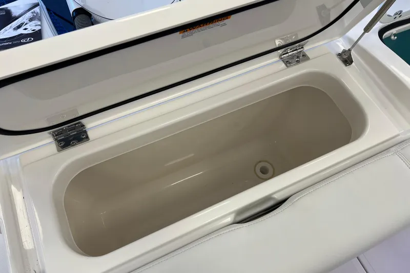 Slide: The Image of Open storage compartment on 2025 Pursuit DC 246 Dual Console boat. - 11