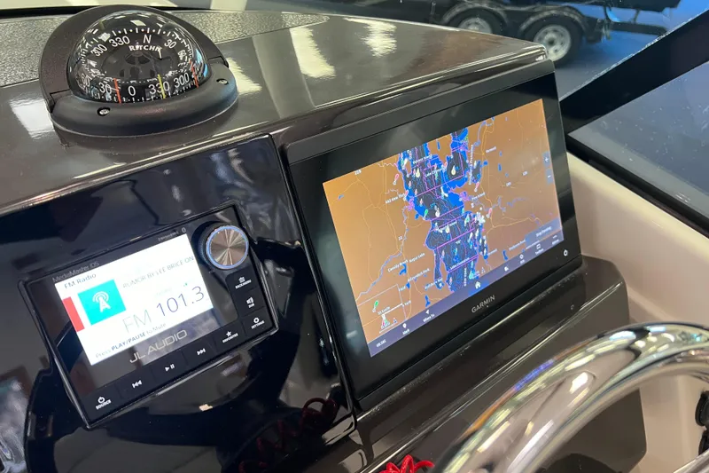 Slide: The Image of Dashboard of 2025 Pursuit DC 246 Dual Console with navigation and audio systems. - 23