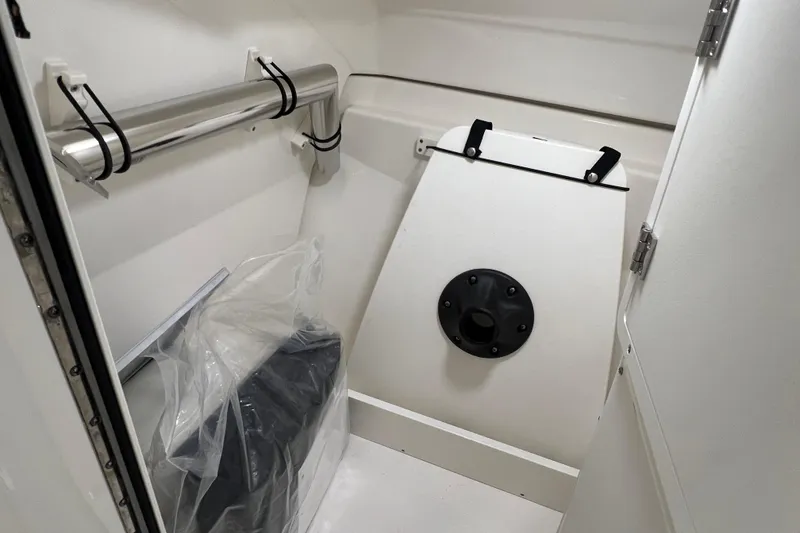 Slide: The Image of Interior of 2025 Pursuit DC 246 Dual Console boat, featuring storage compartment and sleek design. - 30