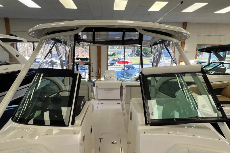 Slide: The Image of 2025 Pursuit DC 246 Dual Console boat interior with modern design and spacious seating. - 35