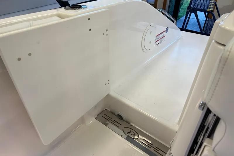 Slide: The Image of 2025 Pursuit DC 246 Dual Console boat interior, featuring sleek white surfaces and modern design elements. - 8