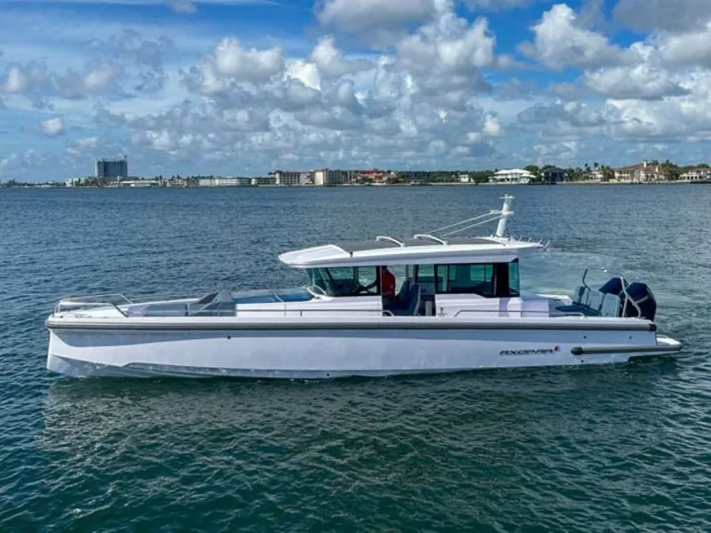 The Image of 2024 Axopar 37XC CROSS CABIN boat on open water under blue sky. - 0