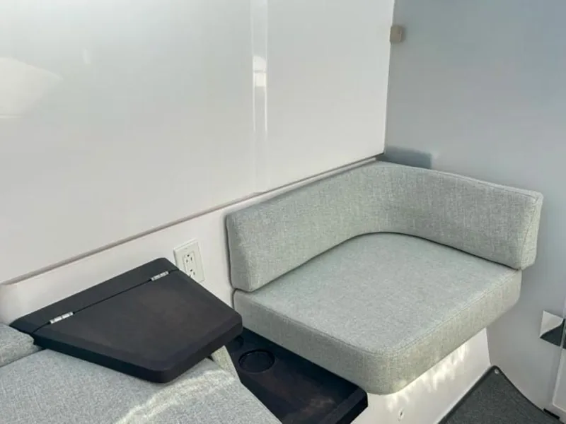 Slide: The Image of 2024 Axopar 37XC CROSS CABIN interior with modern seating and sleek design. - 12