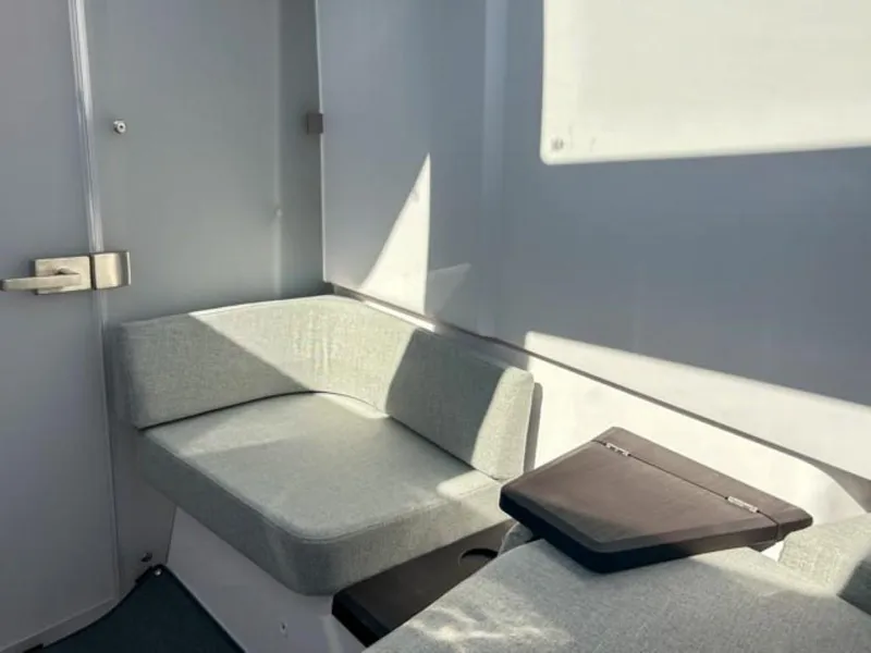 Slide: The Image of 2024 Axopar 37XC CROSS CABIN interior with gray seating and modern design. - 13