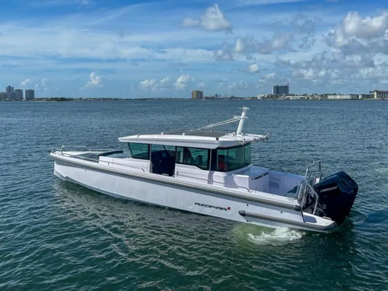 Slide: The Image of 2024 Axopar 37XC CROSS CABIN cruising on a sunny day. - 2