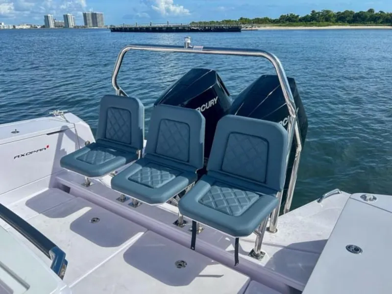 Slide: The Image of 2024 Axopar 37XC CROSS CABIN boat with triple seats and dual Mercury engines on water. - 21