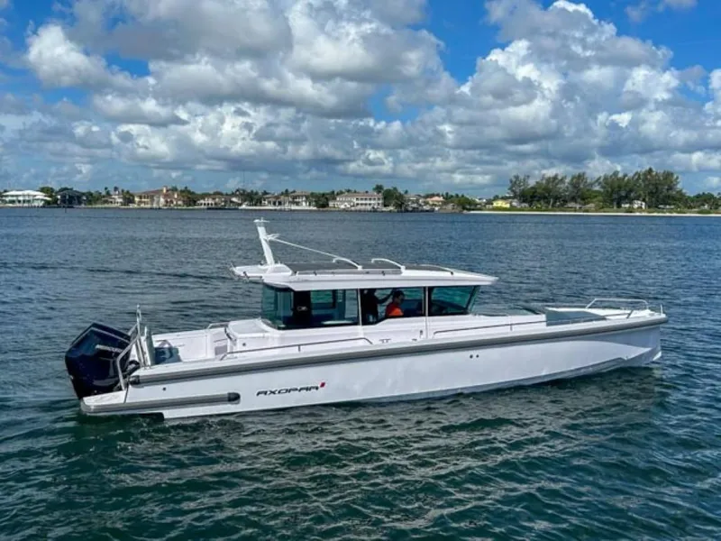 Slide: The Image of 2024 Axopar 37XC CROSS CABIN boat cruising on a sunny day. - 3