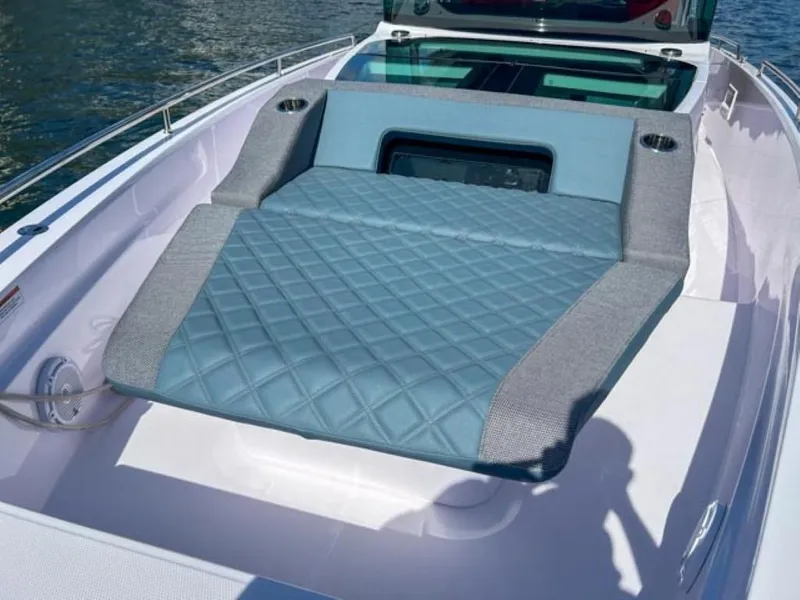 Slide: The Image of 2024 Axopar 37XC CROSS CABIN with luxurious sunbed on deck. - 6