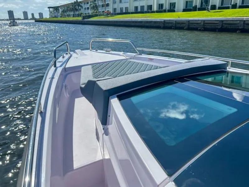 Slide: The Image of 2024 Axopar 37XC CROSS CABIN on water, featuring sleek design and spacious deck. - 7