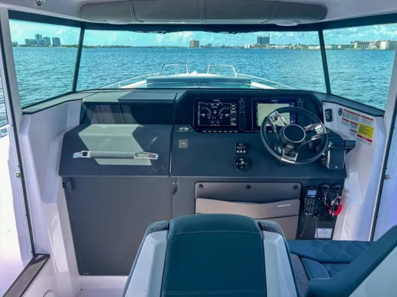 Slide: The Image of 2024 Axopar 37XC CROSS CABIN helm with modern controls and panoramic view. - 8