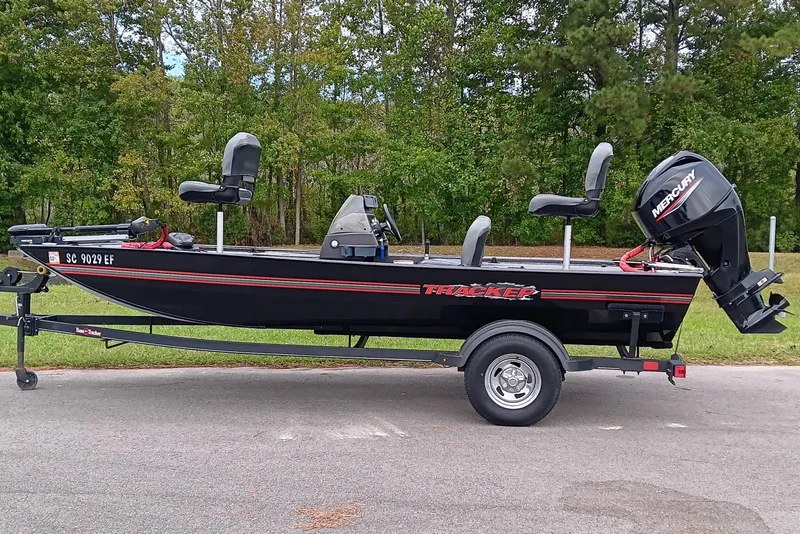 The Image of 2023 Tracker Bass Tracker Classic XL boat on trailer, parked outdoors. - 0