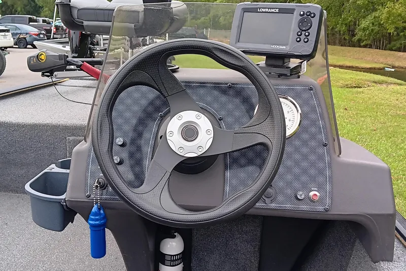 Slide: The Image of 2023 Tracker Bass Tracker Classic XL dashboard with steering wheel and fish finder. - 11