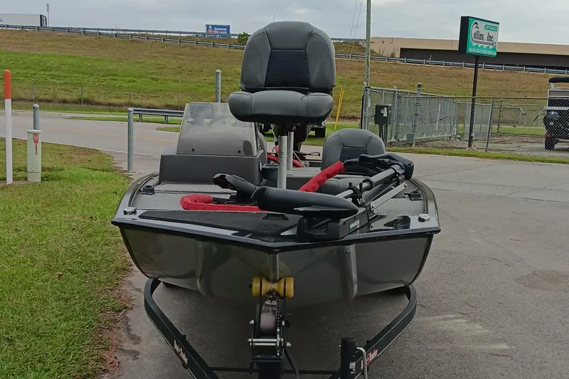 Slide: The Image of 2023 Tracker Bass Tracker Classic XL boat on trailer, parked near road and grassy area. - 7