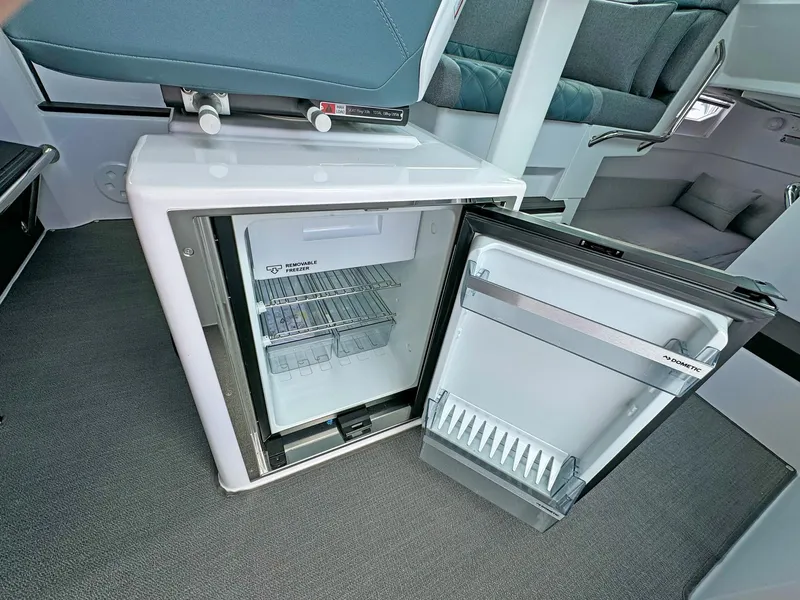 Slide: The Image of 2024 Axopar 37XC CROSS CABIN interior with open mini fridge. - 13