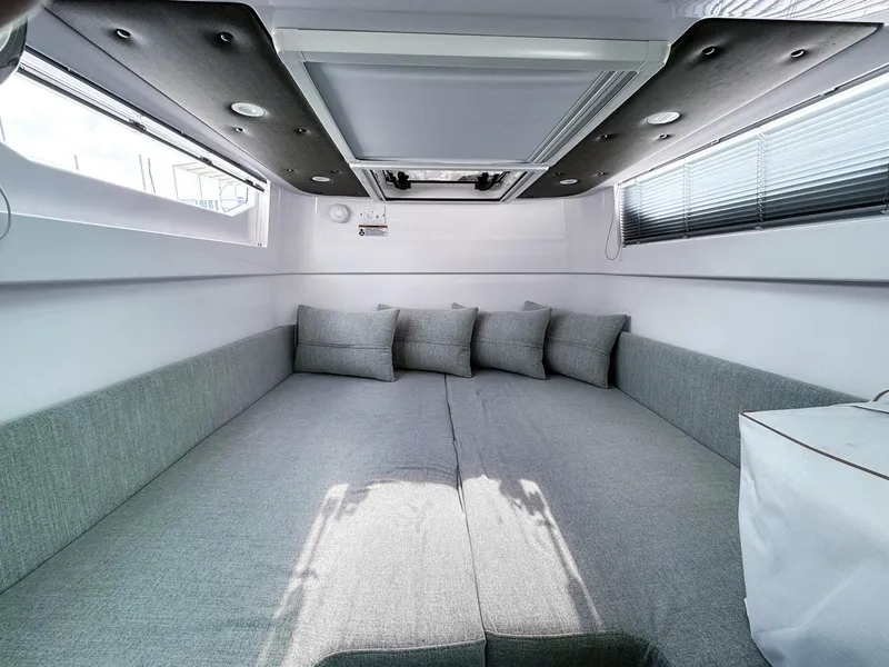 Slide: The Image of 2024 Axopar 37XC CROSS CABIN interior with gray seating and cushions. - 16