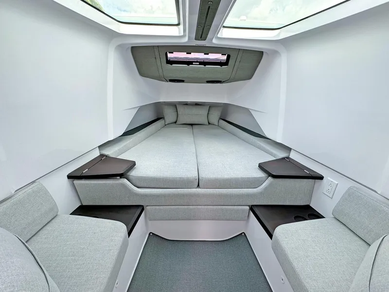 Slide: The Image of 2024 Axopar 37XC CROSS CABIN interior with modern, spacious sleeping area and skylights. - 10
