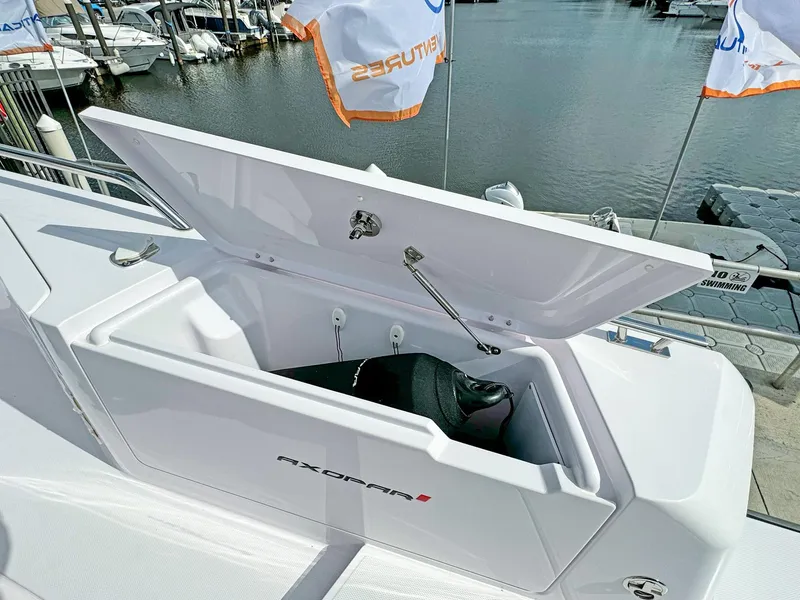 Slide: The Image of 2024 Axopar 37XC CROSS CABIN storage compartment open at marina. - 17