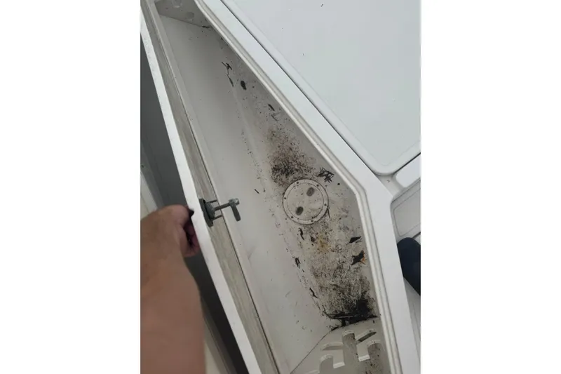 Slide: The Image of Open storage compartment on 2004 Fountain 31 Sportfish CC, showing interior condition. - 11