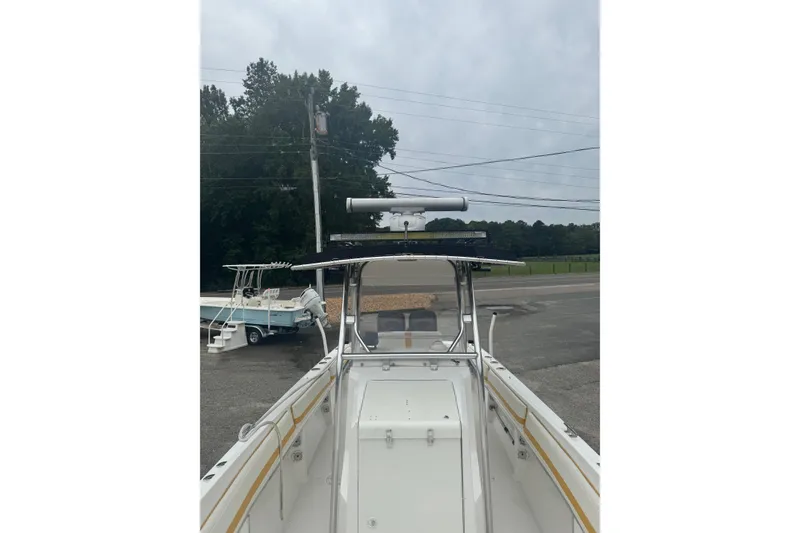 Slide: The Image of 2004 Fountain 31 Sportfish CC Open Bow boat, parked outdoors, overcast sky. - 14