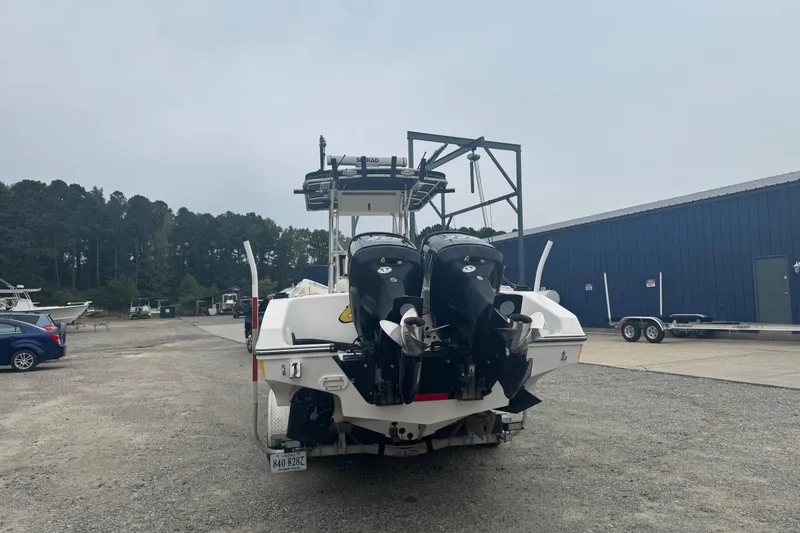 Slide: The Image of 2004 Fountain 31 Sportfish CC Open Bow with dual outboard motors in a boatyard. - 2