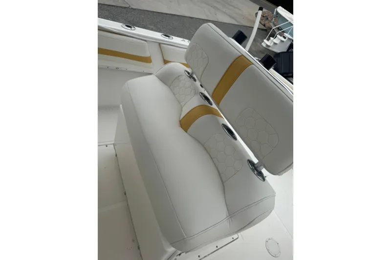 Slide: The Image of 2004 Fountain 31 Sportfish CC Open Bow boat seating with white and yellow upholstery. - 21