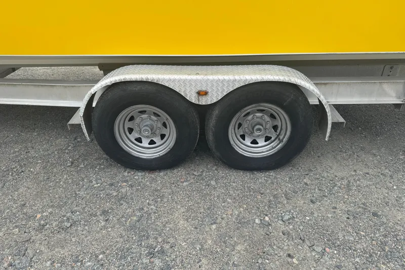 Slide: The Image of Trailer wheels of a 2004 Fountain 31 Sportfish CC Open Bow boat. - 24