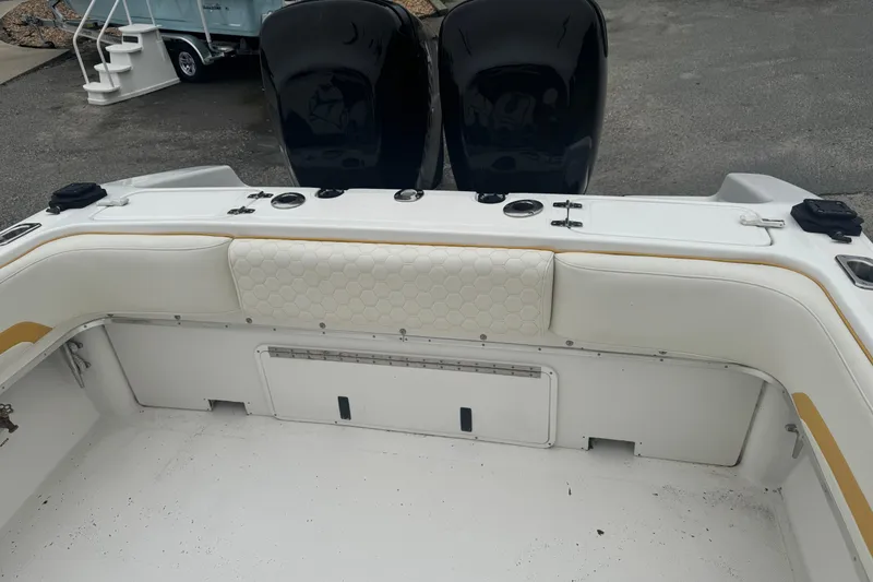 Slide: The Image of 2004 Fountain 31 Sportfish CC Open Bow, white seating area with dual engines. - 3