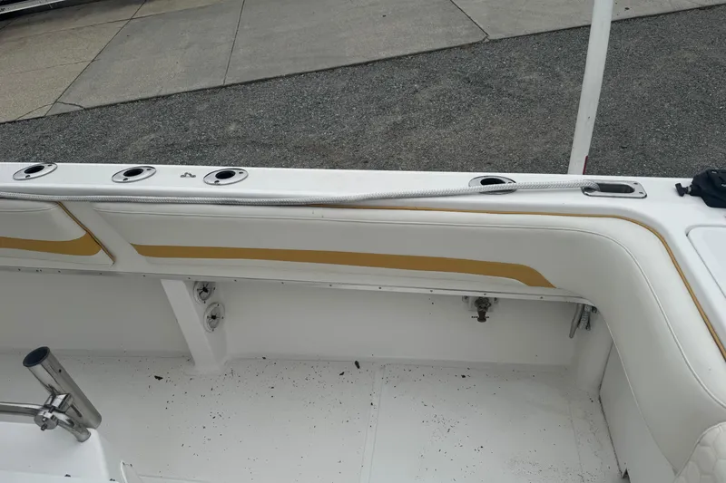 Slide: The Image of 2004 Fountain 31 Sportfish CC Open Bow interior with rod holders and seating. - 8