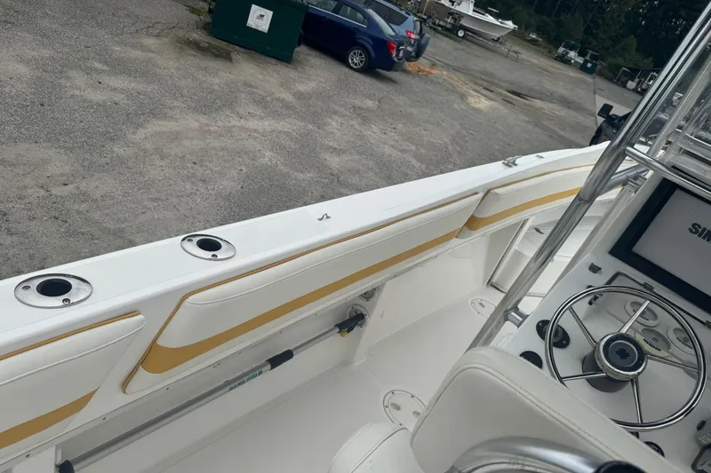 Slide: The Image of 2004 Fountain 31 Sportfish CC Open Bow boat interior with steering wheel and rod holders. - 9